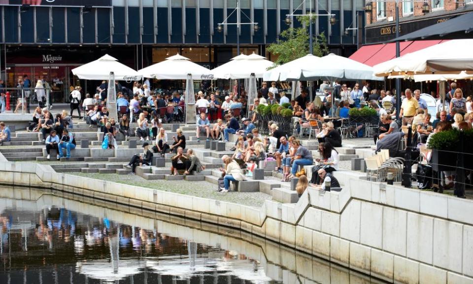 People relaxing at canal, Aaboluvarden, Aarhus