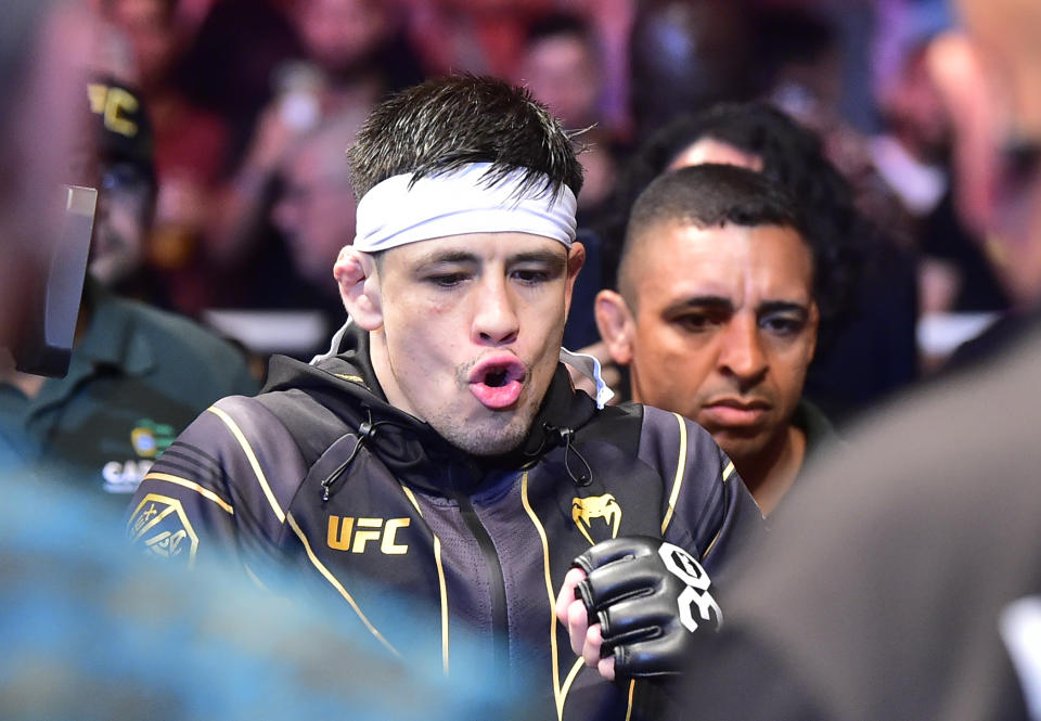 Jan 21, 2023; Rio de Janeiro, Brazil; Brandon Moreno (blue gloves) enters the arena before the fight against Deiveson Figueiredo (red gloves) during UFC 283 at Jeunesse Arena. Mandatory Credit: Jason da Silva-USA TODAY Sports