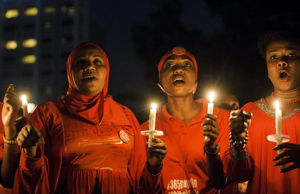 People hold candles during a vigil for the girls who were abducted from a secondary school in Chibok, on the anniversary of their abduction in Abuja