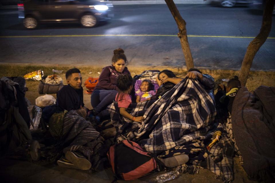 Central American migrants in caravan — made up mostly of Hondurans — who are traveling to the U.S. rest in a Mexicali, Baja California State, Mexico, park on Tuesday. (Photo: by Pedro Pardo/AFP/Getty Images)