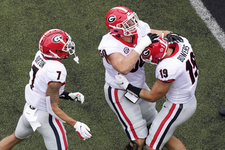 Georgia tight end Brock Bowers (19) is congratulated by Jermaine Burton (7) and Warren Ericson (50) after Bowers scored a touchdown against Vanderbilt in the first half of an NCAA college football game Saturday, Sept. 25, 2021, in Nashville, Tenn. (AP Photo/Mark Humphrey)