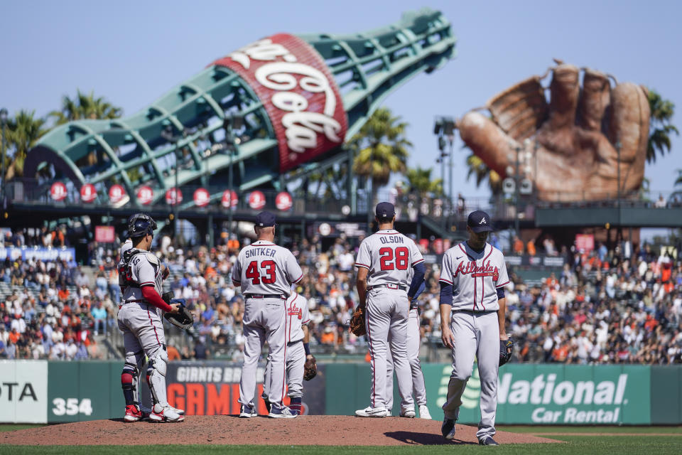 Atlanta Braves starting pitcher Charlie Morton, right, is pulled from a baseball game against the San Francisco Giants during the sixth inning in San Francisco, Wednesday, Sept. 14, 2022. (AP Photo/Godofredo A. Vásquez)