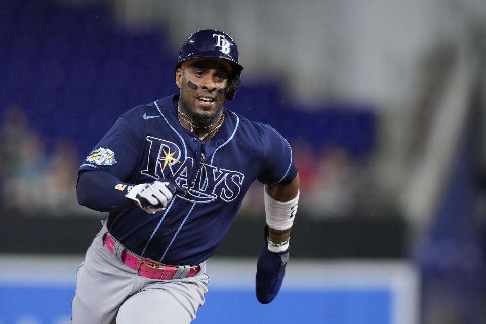 Tampa Bay Rays' Yandy Diaz advances to third base on a fielding error by Miami Marlins center fielder Jazz Chisholm Jr. during the first inning of a baseball game, Tuesday, Aug. 29, 2023, in Miami. (AP Photo/Wilfredo Lee)