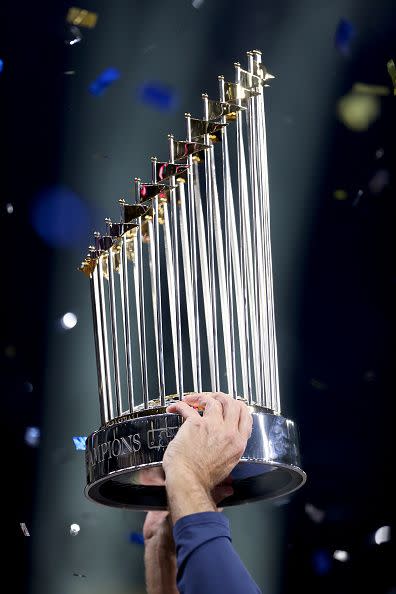 HOUSTON, TEXAS - NOVEMBER 02:  The Commissioner's Trophy is held following the Atlanta Braves 7-0 victory against the Houston Astros in Game Six to win the 2021 World Series at Minute Maid Park on November 02, 2021 in Houston, Texas. (Photo by Elsa/Getty Images)