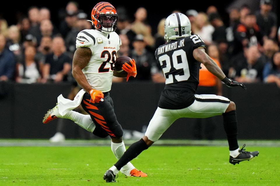 Cincinnati Bengals running back Joe Mixon (28) carries the ball as Las Vegas Raiders cornerback Casey Hayward (29) defends in the first quarter during a NFL Week 11 game, Sunday, Nov. 21, 2021, at Allegiant Stadium in Las Vegas.