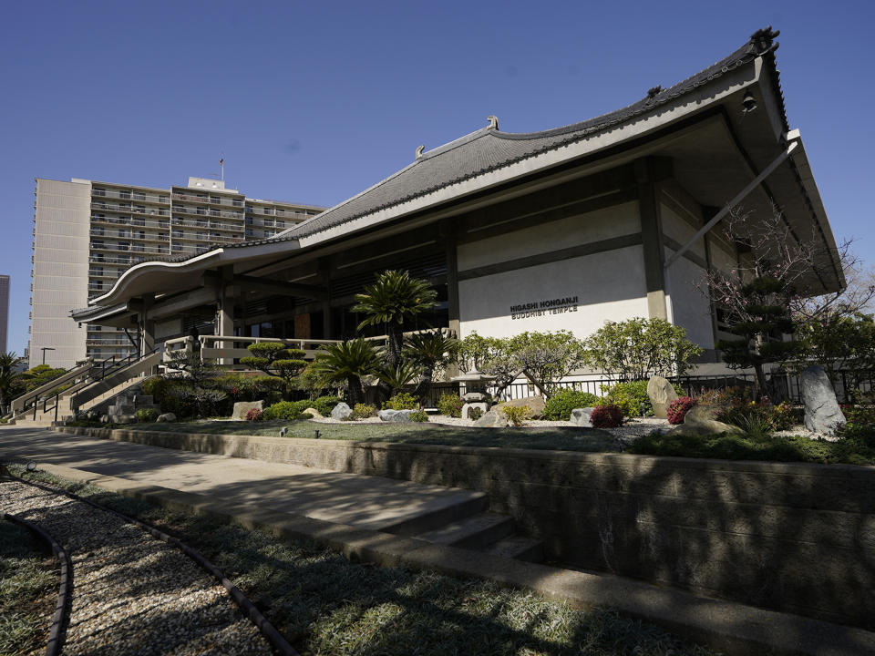 The Higashi Honganji Buddhist Temple is seen in Los Angeles Saturday, Feb. 27, 2021. Authorities are investigating the vandalism and fire at the Buddhist temple in the Little Tokyo section of downtown Los Angeles. Authorities are investigating a vandalism and fire at a Buddhist temple in the Little Tokyo section of downtown Los Angeles. Surveillance video caught a man jumping the security fences at the Higashi Honganji Buddhist Temple on Thursday night, smashing a 12-foot-high glass window with a rock, yanking a pair of metallic lanterns off their concrete bases and lighting two wooden lantern stands on fire, the temple's head priest told the Los Angeles Times. (AP Photo/Damian Dovarganes)