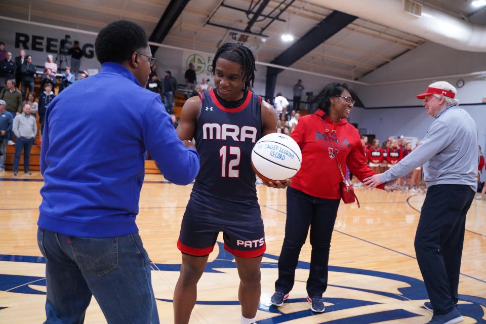 Madison-Ridgeland Academy Rebels Josh Hubbard (12) reacts with his father Jason Hubbard after the game against the Presbyterian Christian School Bobcats during the 2023 Class 6A basketball tournament. Hubbard broke Mississippi's all-time scoring record during the game on Friday. 