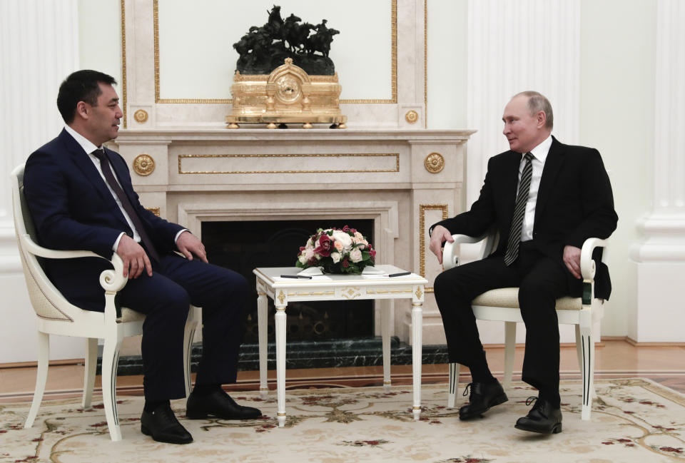 Russian President Vladimir Putin, right, and Kyrgyzstan's President Sadyr Japarov speak during their meeting in Moscow, Russia, Wednesday, Feb. 24, 2021. (Mihail Metzel, Sputnik, Kremlin Pool Photo via AP)