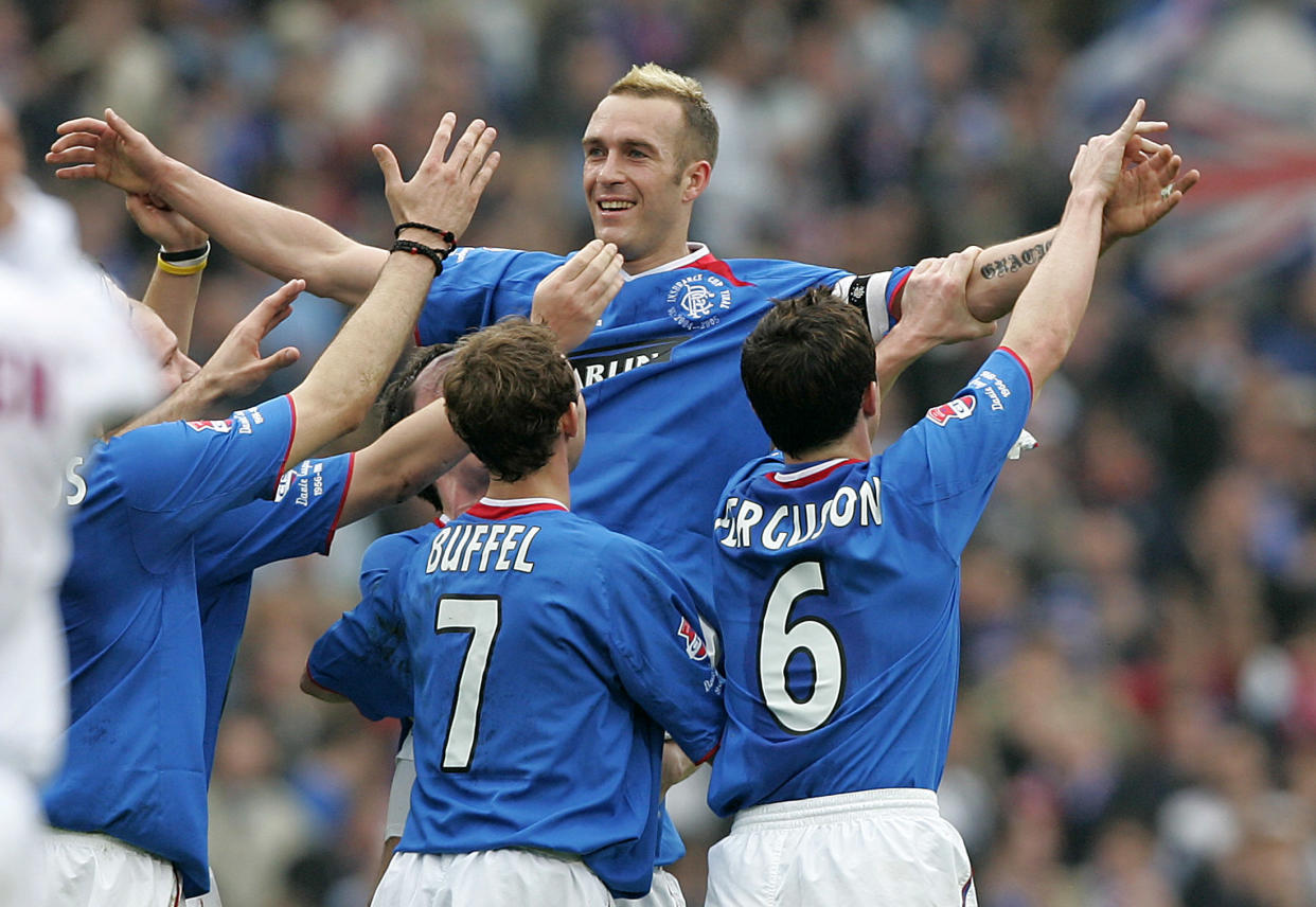 Rangers Fernando Ricksen celebrates with Maurice Ross Thomas Buffel and Barry Ferguson after scoring against Motherwell.  Rangers Fernando Ricksen celebrates with Maurice Ross Thomas Buffel (L) and Barry Ferguson (R) after scoring against Motherwell during the Scottish League Cup Final at Hampden Glasgow March 20, 2005. REUTERS/Jeff J Mitchell REUTERS