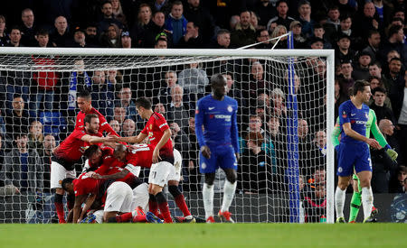 Soccer Football - FA Cup Fifth Round - Chelsea v Manchester United - Stamford Bridge, London, Britain - February 18, 2019 Manchester United's Paul Pogba celebrates scoring their second goal with Juan Mata and team mates as Chelsea's Cesar Azpilicueta and team mates look dejected REUTERS/David Klein