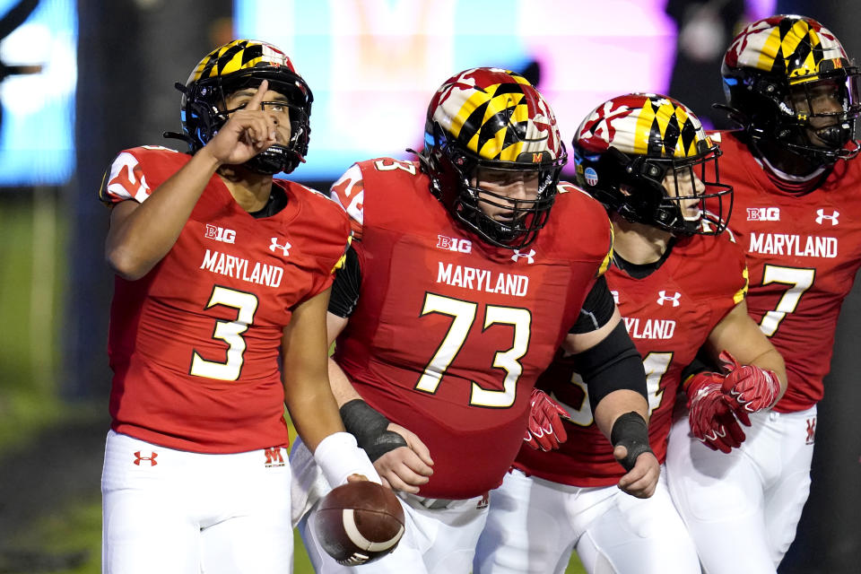 Maryland quarterback Taulia Tagovailoa, far left, reacts after scoring a touchdown on a run against Minnesota during the first half of an NCAA college football game, Friday, Oct. 30, 2020, in College Park, Md. (AP Photo/Julio Cortez)