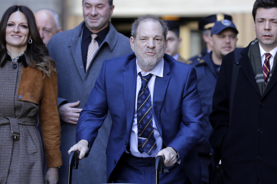 Harvey Weinstein, center, leaves a Manhattan courthouse after closing arguments in his rape trial in New York, Friday, Feb. 14, 2020. (AP Photo/Seth Wenig)