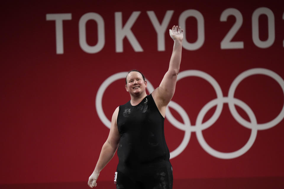 Laurel Hubbard of New Zealand waves after a lift, in the women's +87kg weightlifting event at the 2020 Summer Olympics, Monday, Aug. 2, 2021, in Tokyo, Japan. (AP Photo/Luca Bruno)