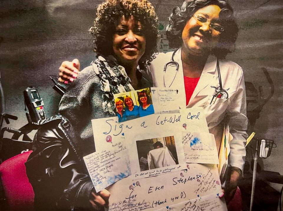 From left, in a photo from 2018, MS patient Eren Stephens of Detroit gets a hug from Southfield neurologist Dr. Tessie Jenkins at Jenkins' clinic while the two display a poster-size get-well card assembled for Jenkins by her husband. Signatures on the card surround a photo of Stephens sitting up in bed at Ascension Providence Hospital, and holding a sheet to her face because she didn't want to be photographed in her hospital gown.