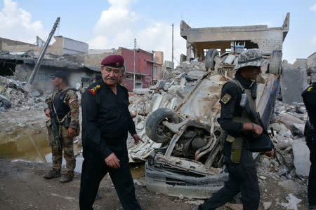 Major General Abdul Ghani al-Asadi, a commander of the Counter Terrorism Service (CTS) walks at the site after an air strike attack against Islamic State triggered a massive explosion in Mosul, Iraq March 29, 2017. REUTERS/Stringer FOR EDITORIAL USE ONLY. NO RESALES. NO ARCHIVES.