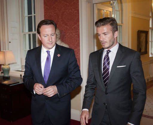 Britain's prime minister David Cameron (L) meets with soccer player David Beckham at Downing Street in London. Cameron insisted Thursday that Britain would deliver a memorable Olympics after US presidential hopeful Mitt Romney backtracked on barbed comments he made about the London Games