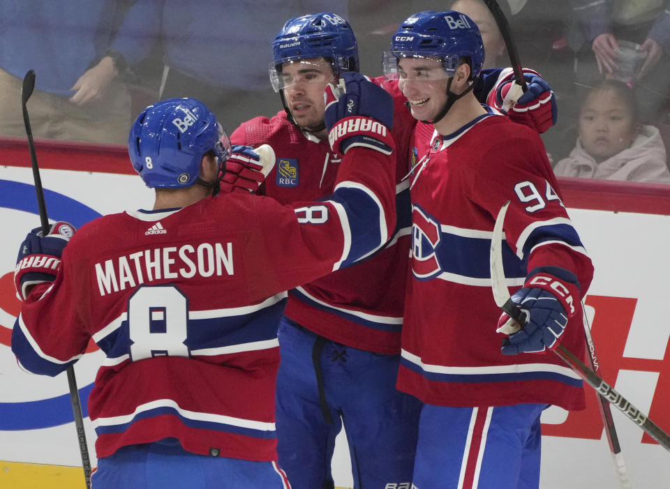 Montreal Canadiens' Alex Newhook (15) celebrates his goal against the Detroit Red Wings with Logan Mailloux (94) and Mike Matheson (8) during the first period of an NHL hockey game Tuesday, April 16, 2024, in Montreal. (Christinne Muschi/The Canadian Press via AP)