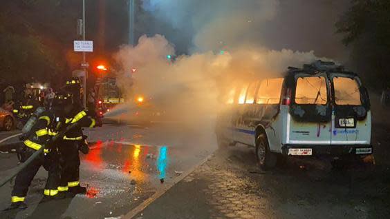 In this photo provided by Khadijah, firefighters work to contain the flames from a New York City Police Department van ablaze, Friday, May 29, 2020, in the Brooklyn borough of New York, amid a protest of the death of George Floyd in police custody on Memorial Day in Minneapolis. (Khadijah via AP) (AP)