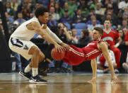 <p>Villanova guard Jalen Brunson (1) is defended by Wisconsin guard Zak Showalter, right, during the first half of a second-round men’s college basketball game in the NCAA Tournament, Saturday, March 18, 2017, in Buffalo, N.Y. (AP Photo/Bill Wippert) </p>