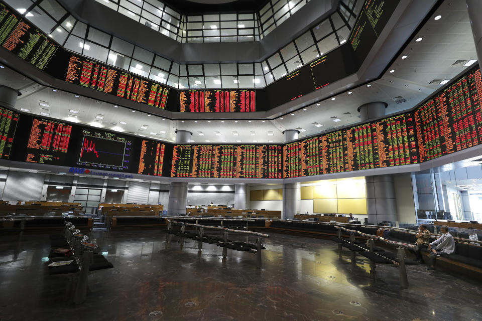 Investors sit in front of stock trading boards at a private stock market gallery in Kuala Lumpur, Malaysia, Thursday, July 18, 2019. Asian stock markets on Thursday followed Wall Street lower after President Donald Trump reignited trade fears by saying he could impose more tariffs on Chinese imports. (AP Photo/Vincent Thian)