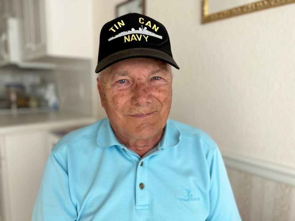 John Siko, now 90, shows off his TIN CAN NAVY hat in the kitchen of his south Fort Myers home. The phrase "tin can" refers to destroyer-class ships like the USS Walker. He served on that ship from 1950-1953, during the secret nuclear tests of Project Greenhouse.