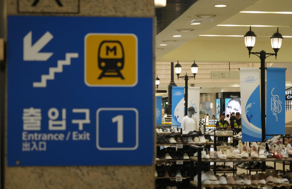 Police officers cordon off the scene near a subway station in Seongnam, South Korea, Thursday, Aug. 3, 2023. A dozen of people were injured in South Korea on Thursday when a man rammed a car onto a sidewalk and then stepped out of the vehicle and began stabbing people near a subway station in the city of Seongnam. (AP Photo/Ahn Young-joon)