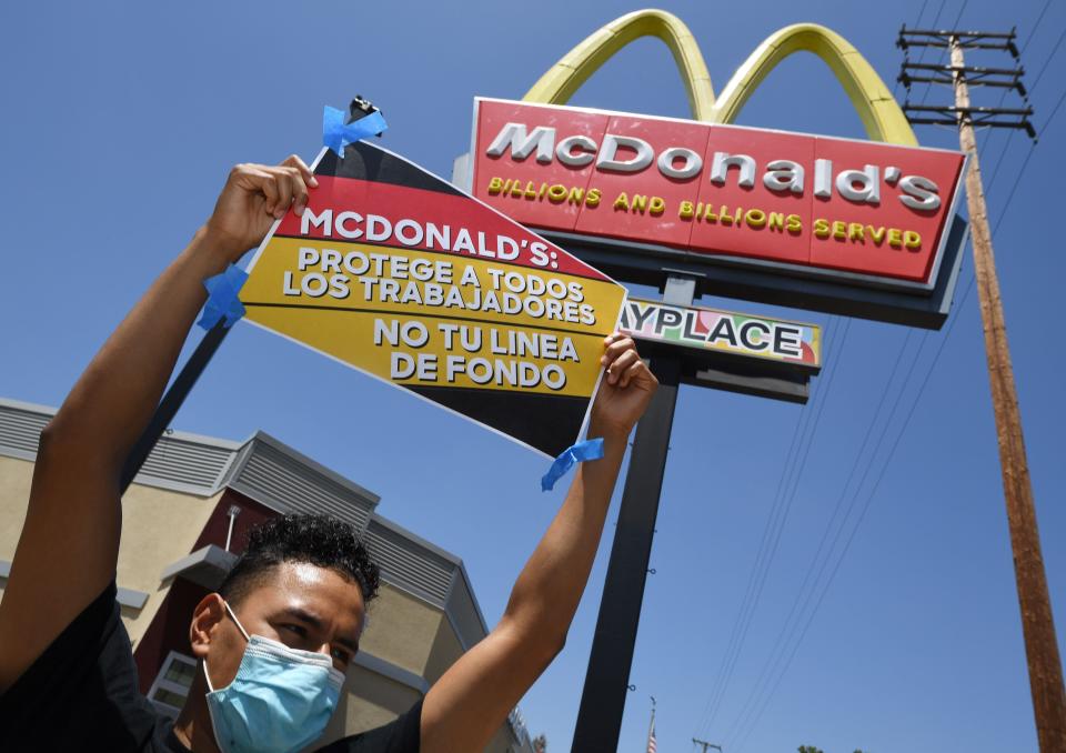 Workers protest outside a California McDonald's over alleged unsafe working conditions in the pandemic. A new study shows that essential workers like cooks are more likely to die of COVID-19 than other workers. (Photo: ROBYN BECK via Getty Images)