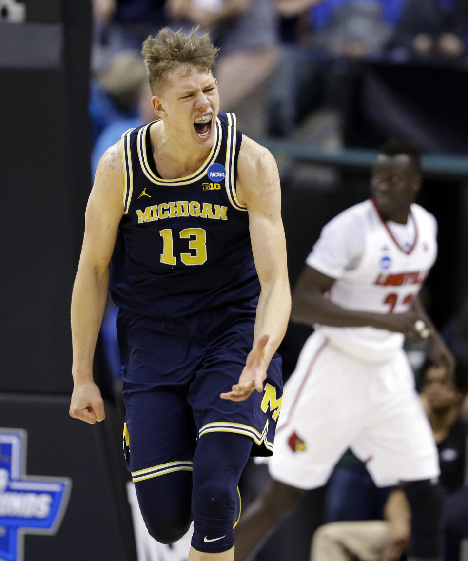 Michigan forward Moritz Wagner (13) celebrates a basket against Louisville during the first half of a second-round game in the men’s NCAA college basketball tournament in Indianapolis, Sunday, March 19, 2017. (AP Photo/Michael Conroy)