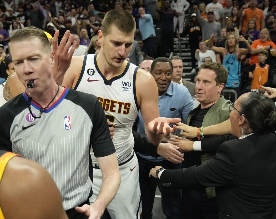 Denver Nuggets center Nikola Jokic (15) throws his arms up after an altercation with fans and Suns majority owner Mat Ishbia during the second quarter of Game 4 of the Western Conference semifinals at Footprint Center in Phoenix on May 7, 2023.