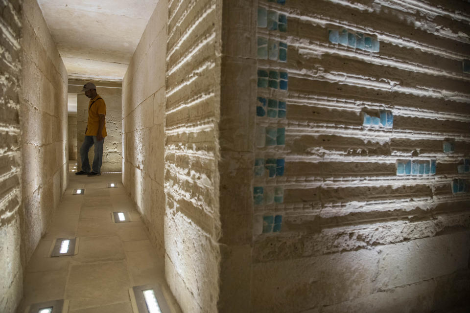 A worker stands inside the southern cemetery of King Djoser, after its restoration, near the famed Step Pyramid, in Saqqara, south of Cairo, Egypt, Tuesday, Sept. 14, 2021. (AP Photo/Nariman El-Mofty)