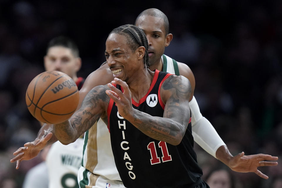 Chicago Bulls forward DeMar DeRozan (11) passes the ball in front of Boston Celtics center Al Horford, behind right, in the second half of an NBA In-Season Tournament basketball game, Tuesday, Nov. 28, 2023, in Boston. (AP Photo/Steven Senne)