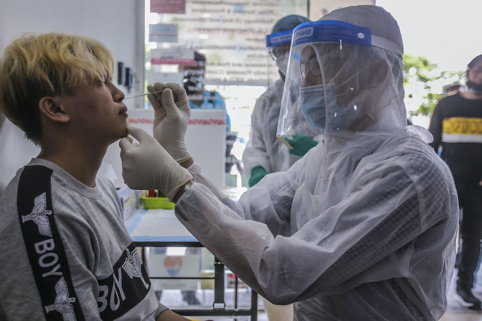 Healthcare workers carry out Covid-19 screening for those with a recent travel history to Sabah at Selcare Clinic in Shah Alam October 4, 2020. — Picture by Hari Anggara