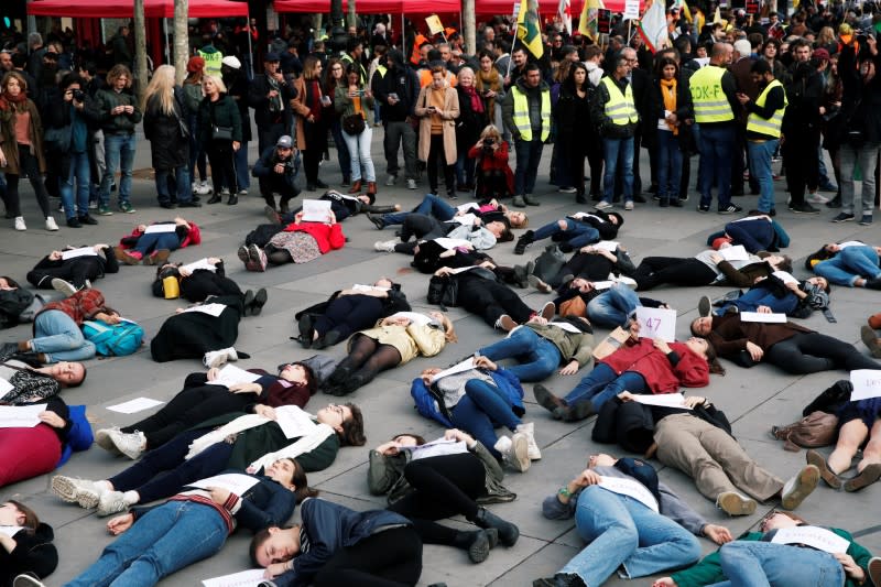 People stage a "die-in" at Place de la Republique during a demonstration against femicide and violence against women in Paris