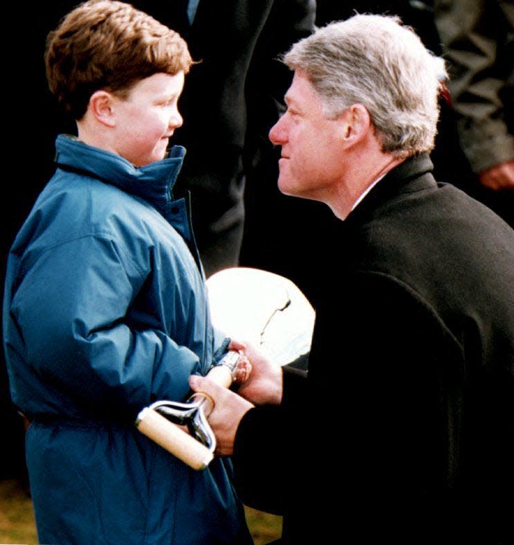 Bill Clinton hands a shovel to six-year-old Nicky Bright of Brookline, Massachusetts