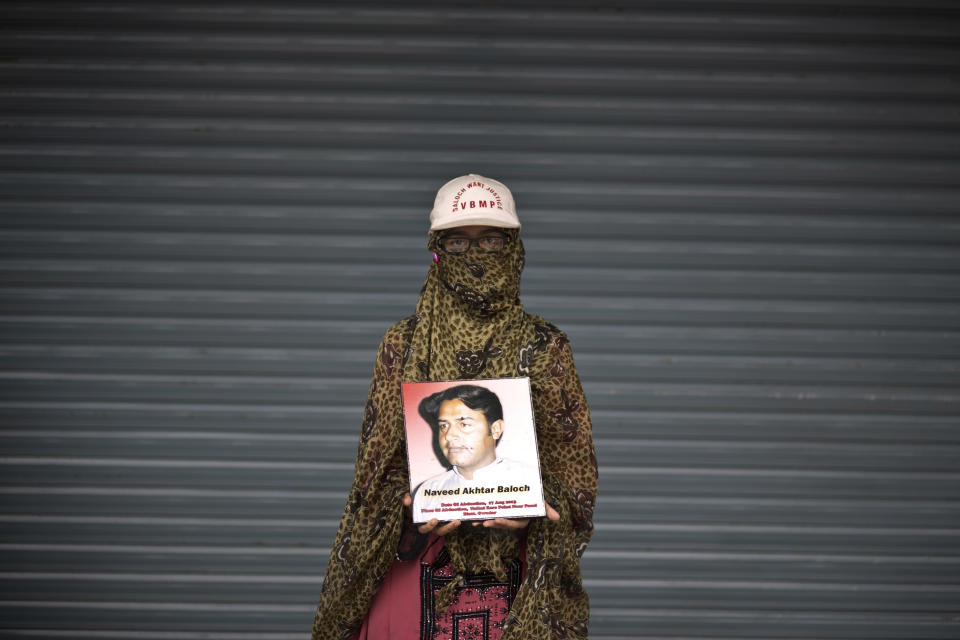 Maheen Baloch, 15, poses for a portrait holding a photograph of her brother Naveed, who went missing on August 17, 2013, while she and other relatives take a break from a long march protest, in Rawalpindi, Pakistan, Friday, Feb. 28, 2014. She is part of a group of activists from the impoverished southwestern province of Baluchistan who walked roughly 3,000 kilometers (1,860 miles) to the capital of Islamabad to draw attention to alleged abductions of their loved ones by the Pakistani government. (AP Photo/Muhammed Muheisen)