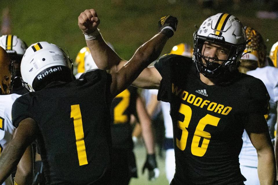 Woodford County’s Jacob Jackson (1) celebrates scoring a touchdown with Preston Stacy (36) during a Yellow Jackets win this season. Woodford County is seeking its first state championship.