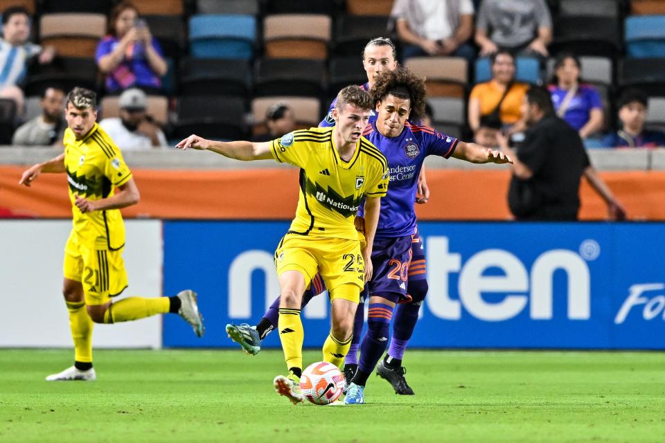 Mar 6, 2024; Houston, TX, USA; Houston Dynamo FC midfielder Coco Carrasquilla (20) and Columbus Crew midfielder Sean Zawadzki (25) battle for possession during the second half at Shell Energy Stadium. Mandatory Credit: Maria Lysaker-USA TODAY Sports