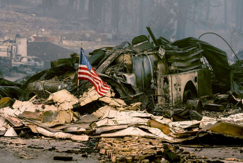 An American flag is placed on a burned fire engine at a burned fire station in downtown Greenville, California on August 7, 2021. - The Dixie Fire has now ravaged 446,723 acres in four counties, up from the previous day's 434,813. That area is larger than Los Angeles -- and has surpassed the sweep of the vast Bootleg Fire in southern Oregon. (Photo by JOSH EDELSON / AFP) (Photo by JOSH EDELSON/AFP via Getty Images)