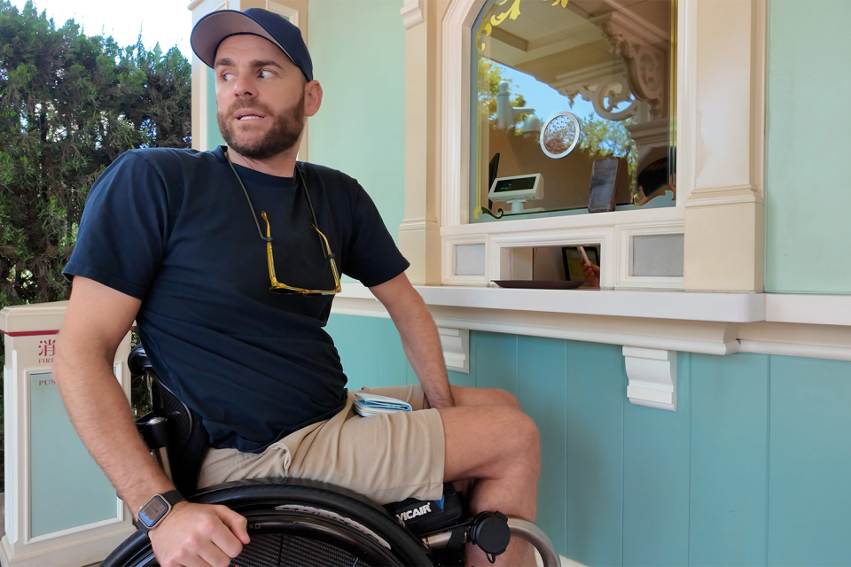 Shane Hryhorec looking uneasy at the Tokyo Disneyland ticket booth.