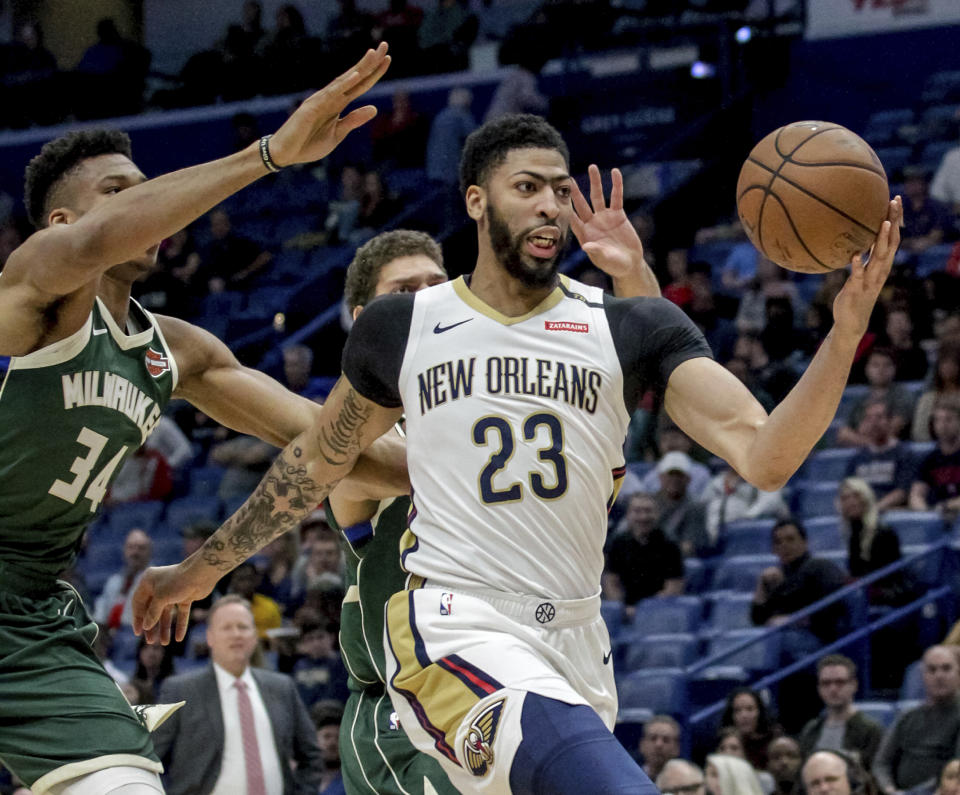 FILE - In this Tuesday, March 12, 2019 file photo, New Orleans Pelicans forward Anthony Davis (23) takes an outlet pass against Milwaukee Bucks forward Giannis Antetokounmpo (34) in the first half of an NBA basketball game in New Orleans. Pelicans basketball operations chief David Griffin says the timing of next week’s NBA draft won’t necessarily raise urgency to trade disgruntled six-time All-Star Anthony Davis. The Pelicans have the first overall pick in the June 20 NBA draft and likely could acquire more high picks by dealing Davis by then.(AP Photo/Scott Threlkeld, File)