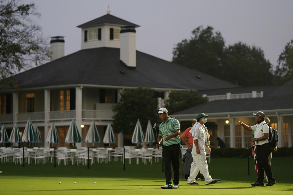 Hideki Matsuyama, of Japan, practices on a putting green outside of the Augusta National Golf Course before the first round of the Masters golf tournament Thursday, Nov. 12, 2020, in Augusta, Ga. (AP Photo/David J. Phillip)