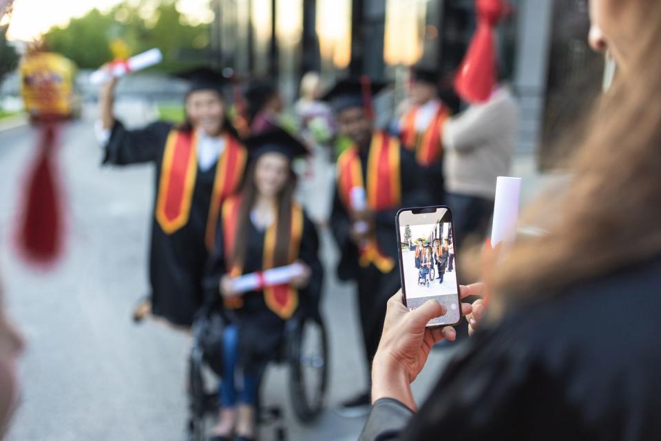 graduation students photographing each other