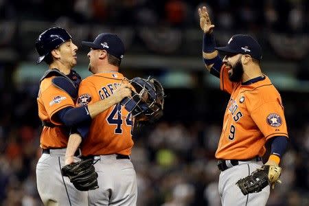 Oct 6, 2015; Bronx, NY, USA; Houston Astros relief pitcher Luke Gregerson (44), first baseman Marwin Gonzalez (9), and catcher Jason Castro (left) celebrate after defeating the New York Yankees in the American League Wild Card playoff baseball game at Yankee Stadium. Houston won 3-0. Adam Hunger-USA TODAY Sports