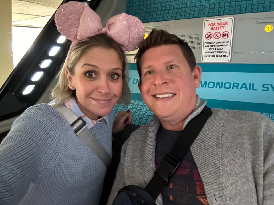 terri and her husband riding the monorail at disney world