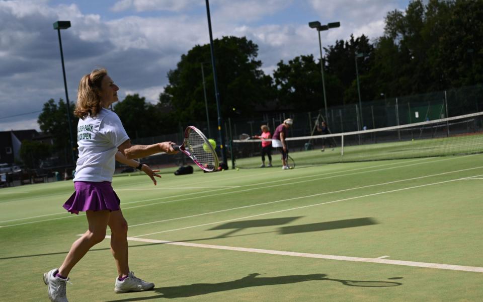 Players enjoy a tennis match at Oakleigh Park Lawn Tennis & Squash Club in London, - SHUTTERSTOCK