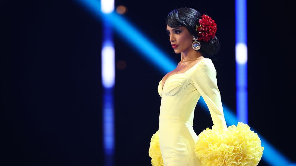 The color palette of Miss Spain's flamenco-inspired gown, which featured dramatic ruffled cuffs and a long train, was inspired by carnations. - Hector Vivas/Getty Images