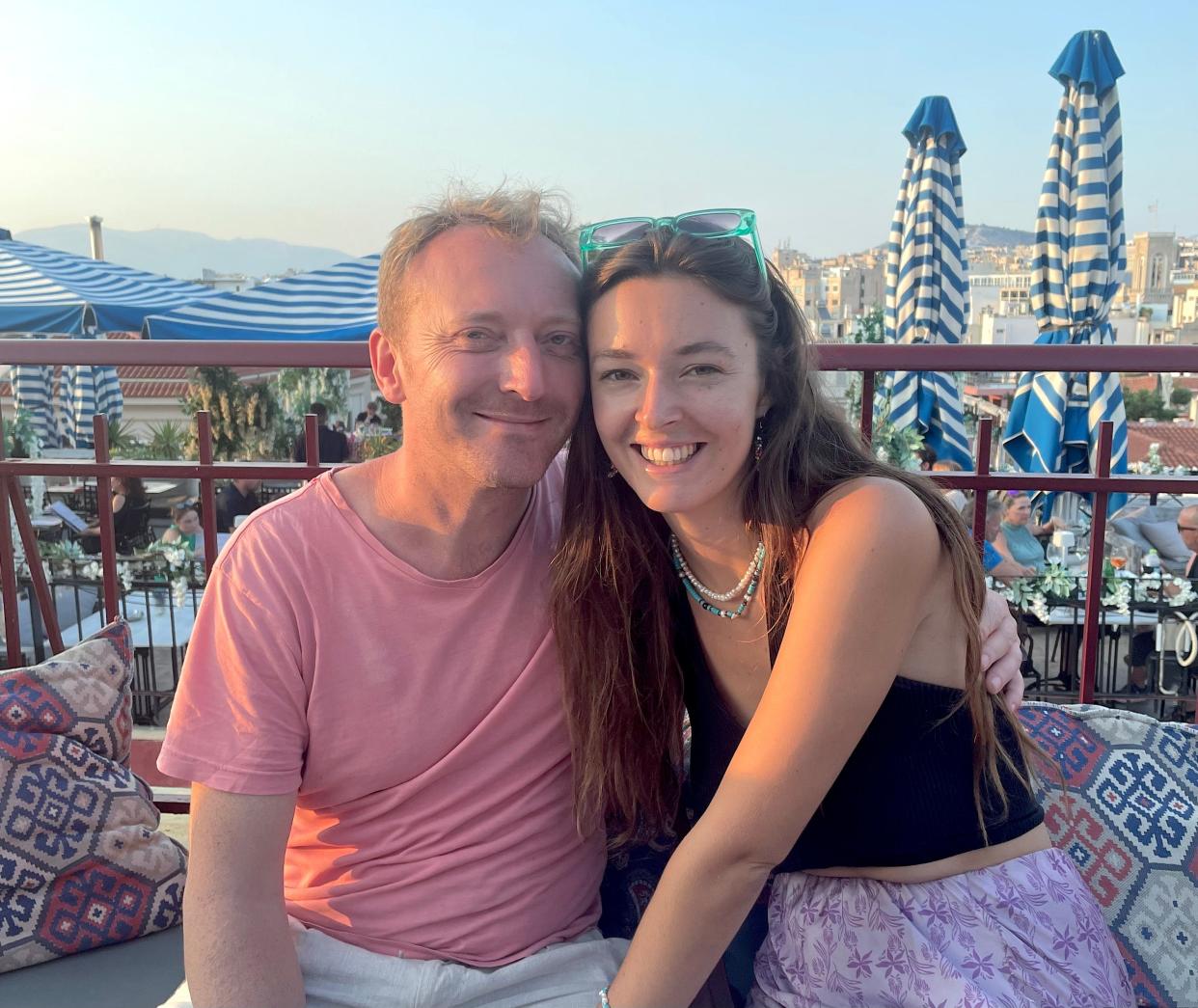 Lara Gibson and her husband Dan smiling and sitting outside.