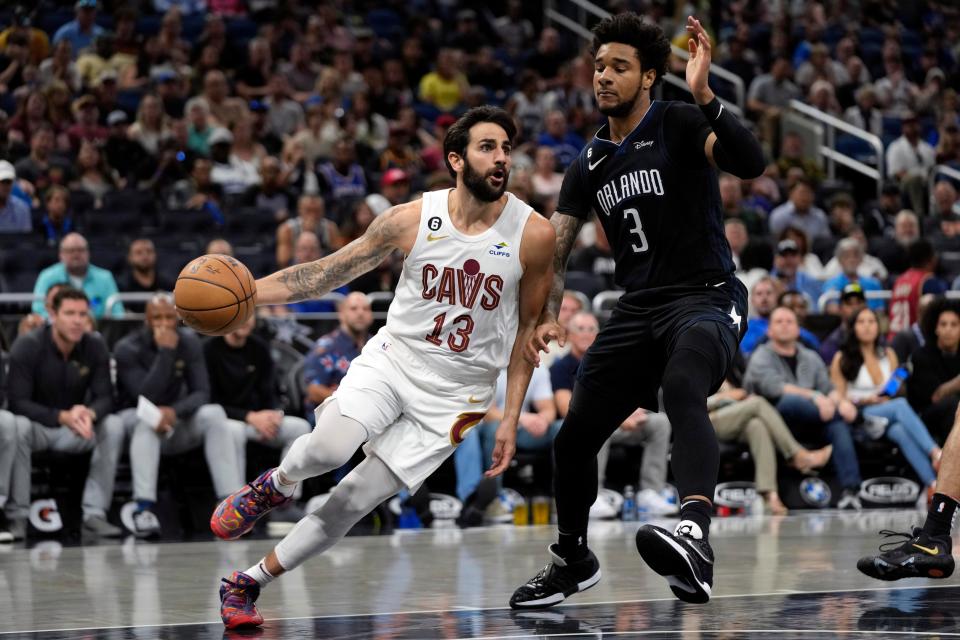 Cleveland Cavaliers' Ricky Rubio (13) drives past Orlando Magic's Chuma Okeke (3) during the first half of an NBA basketball game, Thursday, April 6, 2023, in Orlando, Fla. (AP Photo/John Raoux)