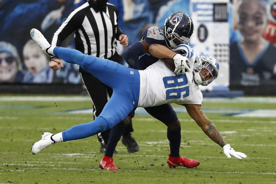 Detroit Lions tight end Hunter Bryant (86) is tackled by Tennessee Titans cornerback Malcolm Butler during the first half of an NFL football game Sunday, Dec. 20, 2020, in Nashville, N.C. (AP Photo/Wade Payne)