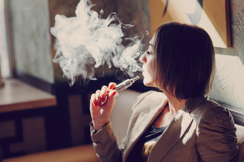 A woman smoking an e-cigarette.
